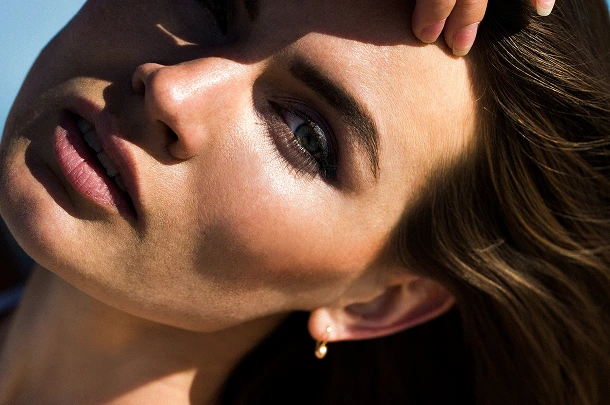 Woman's face in profile showing smooth skin texture and complexion