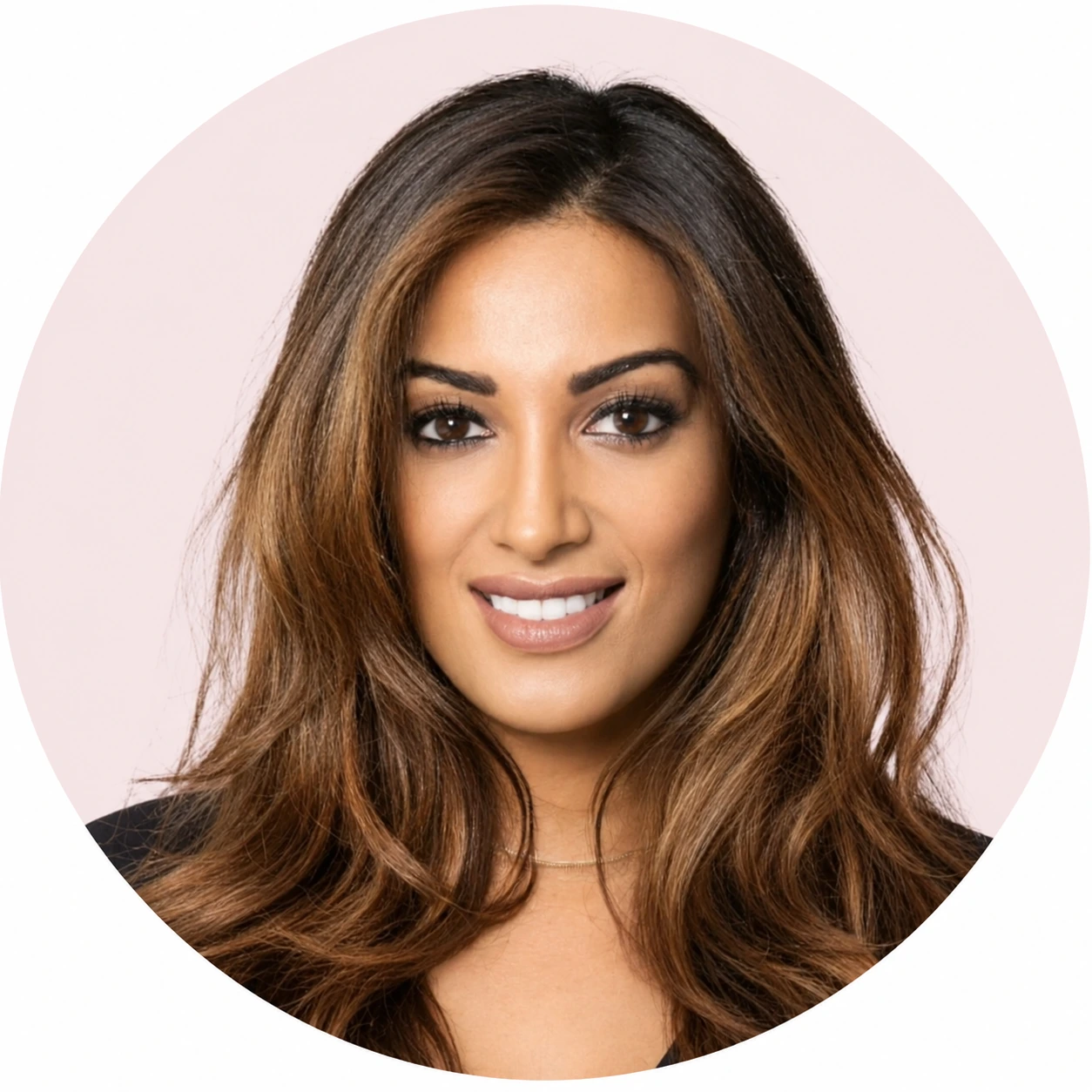 Woman with brown hair smiling against a pink circular background